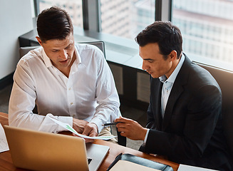 Image showing Going into partnership is the right solution for you. two businessmen having a discussion while sitting by a laptop.