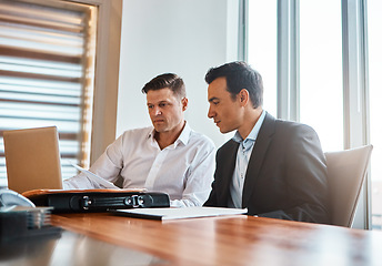 Image showing Will your idea stand apart. two businessmen having a discussion while sitting by a laptop.
