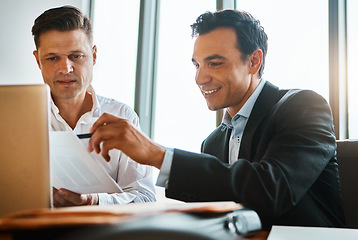 Image showing These are really impressive. two businessmen having a discussion while sitting by a laptop.