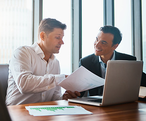 Image showing Are you happy with our agreement. two businessmen having a discussion while sitting by a laptop.