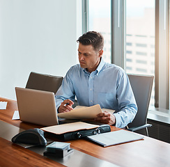 Image showing With the internet, nothing is unreachable. a mature businessman working at his desk.