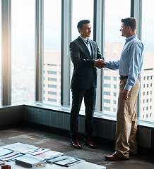 Image showing Dreams and dedication is a powerful combination. two businessmen shaking hands in a corporate office.