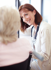 Image showing A comfort to her patients in their time of need. Mature nurse has a friendly conversation with an elderly female patient confined to a wheelchair.