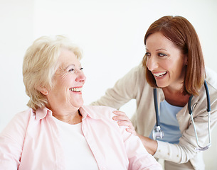 Image showing Friendly banter between doctor and patient. Elderly female patient and her mature nurse share a friendly laugh together.