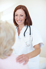 Image showing She understands that every patient needs her comforting attention. Friendly mature nurse comforts her elderly patient with a hand to the shoulder.