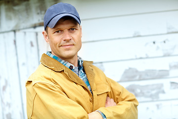 Image showing Hes focused and ready for the days tasks. Portrait of a smiling man with his arms crossed standing outside a shed with copyspace.