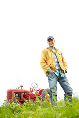 Image showing One of the perks of being a farmer - Nature. Full length portrait of a farmer standing in a field with a tractor parked behind him - Copyspace.
