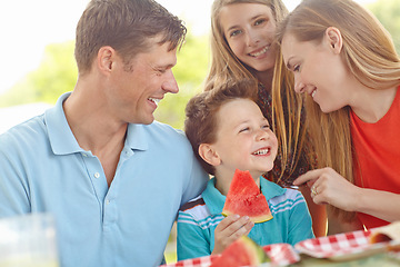 Image showing Spending time outdoors together. Happy attractive family having a picnic in the park.