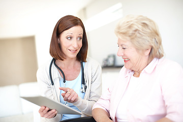 Image showing Congratulations Youre in the clear. Mature nurse gives the good news to her elderly wheelchair-bound patient.