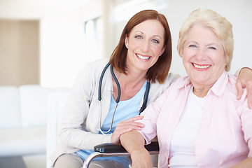 Image showing Reliable and astute senior care. Smiling mature nurse embraces her delighted elderly female patient.