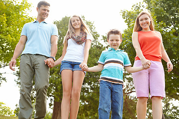 Image showing Spending some quality time together in the park. a happy family walking in the park.