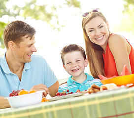 Image showing Are you ready for lunch. A happy young family relaxing in the park and enjoying a healthy picnic.