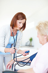 Image showing Checking that her blood pressure is normal - Senior Health. Mature nurse checks an elderly female patients blood pressure.
