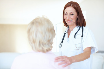 Image showing A conscientious checkup on an adored patient. Friendly mature nurse comforts her elderly patient with a hand to the shoulder.