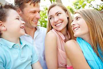 Image showing Quality family time in the park. Happy family smiling while outdoors.