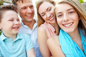 Image showing Portrait of a happy family. Happy family smiling while outdoors.