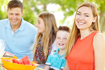 Image showing Having a family is so fulfilling. A happy young family relaxing in the park and enjoying a healthy picnic.