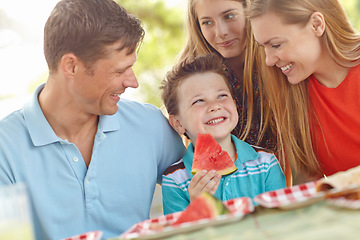 Image showing Family picnic in the park. Happy attractive family having a picnic in the park.