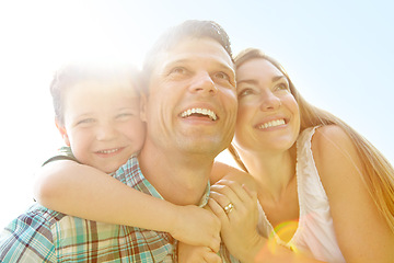 Image showing Looking forward to a brilliant summer. A cute young family spending time together outdoors on a summers day.