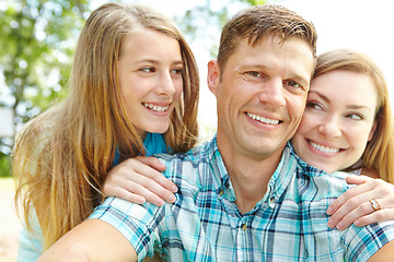 Image showing Hes their number one. A happy young family relaxing together on a sunny day.