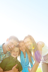 Image showing Family fun in the sunshine. A cute young family spending time together outdoors on a summers day.