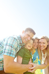 Image showing Bonding on a summers day. A cute young family spending time together outdoors on a summers day.