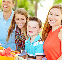 Image showing Enjoying a healthy lifestyle as a family. A happy young family relaxing in the park and enjoying a healthy picnic.