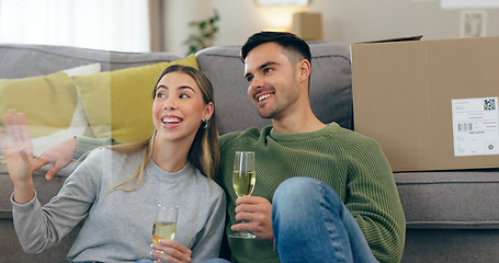 Image showing Happy couple, celebration and champagne for moving home or new property, drink in living room. Man, woman and wine glass for achievement in apartment boxes for change or floor chat, cheers at sofa