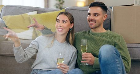 Image showing Couple, move and celebration champagne or boxes talking for pointing furniture or living room, chat or happy. Man, woman and new property cheers drink for apartment change achievement, toast or relax