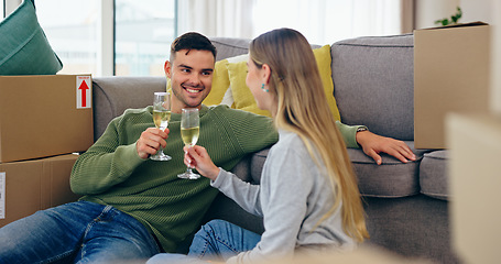 Image showing Couple, moving and home celebration with champagne drink at new property living room, boxes or future. Man, woman and wine glass as achievement happy or apartment change or milestone, cheers at sofa