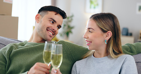 Image showing Couple, new home and toast champagne on sofa for celebration with boxes in living room together. Man, woman and wine glass with cheers, achievement and investment in real estate, property or house