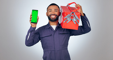 Image showing Portrait, handyman and smartphone with green screen, tool box and smile on white studio background. Face, person and model with cellphone, tracking markers and mechanic with mockup space or promotion