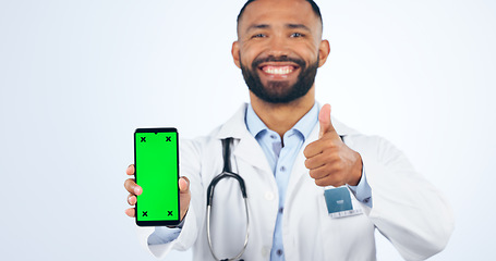 Image showing Phone, green screen and portrait of doctor with thumbs up, agreement or registration in white background. Studio, healthcare or sign for like, yes and ok mobile app for telehealth services or success