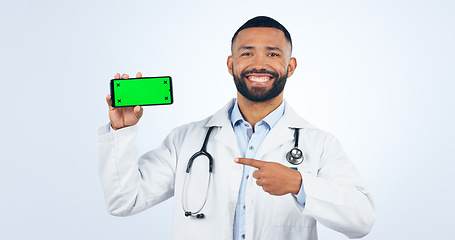 Image showing Phone, green screen and portrait of doctor pointing to registration, sign up or info in white background. Studio, healthcare and mobile app for telehealth services, communication or presentation