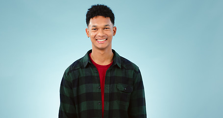 Image showing Portrait, smile and happy man laughing in studio with joke, humor or confidence on blue background. Face, pose and male model with funny, silly or positive attitude, personality or satisfaction