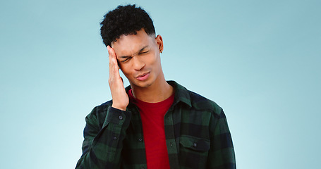 Image showing Tired, studio or man with headache, burnout or fatigue in crisis with head pain or emergency. Depression problem, face or person frustrated by ptsd, migraine or stress isolated on blue background