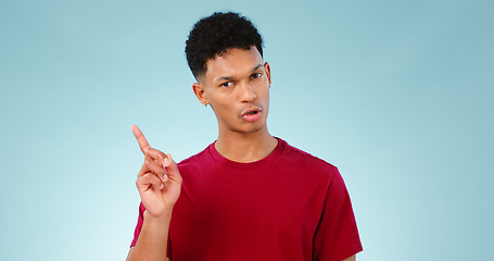 Image showing Portrait, pointing or man with promotion, announcement and information with review on blue background. Face, person or model with sale, hand gesture or mockup space with opportunity, show or feedback