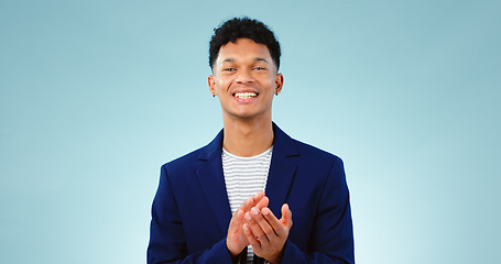 Image showing Man, portrait and clapping hands or celebration studio or business growth, winning or opportunity. Male person, face and applause on blue background as mockup or achievement, congratulations or pride