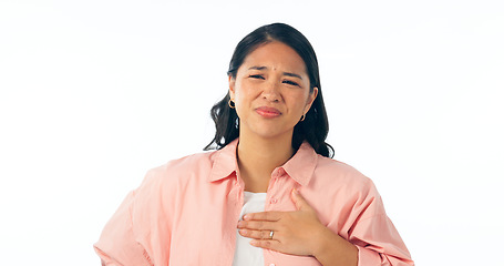 Image showing Chest pain, portrait and woman in studio for heartburn, anxiety or emergency on white background. Stress, face and Asian model with lung, asthma or breathing problem, fail or indigestion reflux