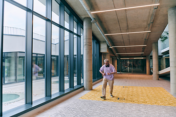 Image showing Amidst an atmosphere of exuberance, a joyful, blonde man energetically departs for a business meeting, radiating positivity, enthusiasm, and a vibrant spirit in the contemporary corporate world