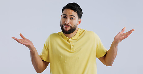 Image showing Man, hands and confused portrait in studio, question and unsure of options by white background. Idea, why and young person with doubt for decision, uncertain and shoulder shrugging by mockup space