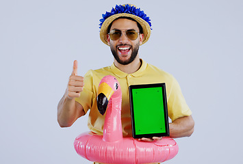 Image showing Green screen, tablet and happy man with thumbs up in studio for travel, review or service feedback on grey background. Digital, space or male traveler smile with emoji vote for app, offer or approval