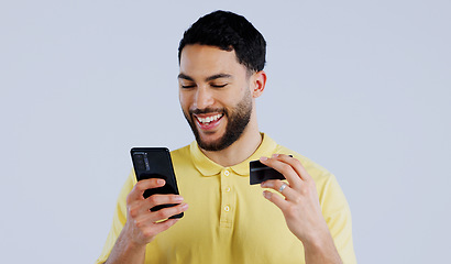 Image showing Man, smartphone and happy with credit card for digital transaction, ecommerce and online shopping on white background. Young person, mobile and technology for iot, banking payment and studio mockup