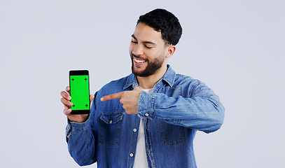 Image showing Man, cellphone or pointing to green screen in portrait, mockup space or happy for advertising. Arab person, smile or face in marketing of tracking markers, mobile app or contact by white background