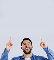 Image showing Man, pointing up and offer in studio with hands to promo, announcement or excited for deal in gray background. Mockup, space or person show choice, decision and gesture to information or opportunity