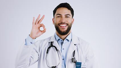 Image showing Happy man, portrait and doctor with OK sign for healthcare approval against a gray studio background. Face of male person or medical professional smile with like emoji, okay or yes for perfect health