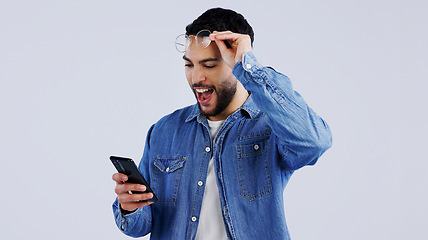 Image showing Man, smartphone and excited with winner notification with surprise on technology, reward offer and white background. Young person, wow and digital news on cellphone, announcement and mockup space