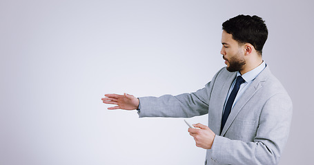 Image showing Business, presentation and space with a man training in studio on a gray background for marketing. Our vision, remote and information with a serious young corporate employee on mockup for advertising