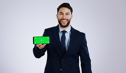 Image showing Business man, phone green screen and presentation for stock market, trading software or registration in studio. Portrait of professional trader with mobile app or website mockup on a white background