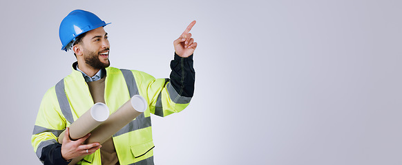 Image showing Smile, pointing and man engineer with blueprint in studio with mockup space for advertising. Happy, marketing and male industrial worker with architect design and show hand gesture by gray background